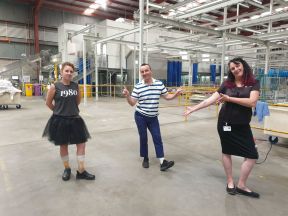 Michelle with coworkers in a factory