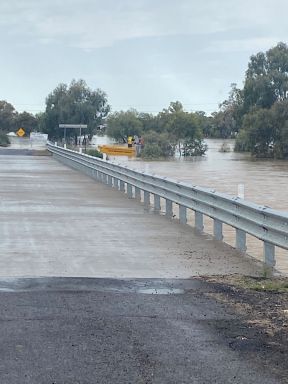 Water flooding over road at Wee Waa
